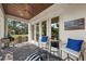 Cozy outdoor patio featuring a ceiling fan, comfortable seating, and an outdoor grill at 4804 W Beachway Dr, Tampa, FL 33609