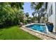 Backyard pool surrounded by lush tropical landscaping and lounge area at 4804 W Beachway Dr, Tampa, FL 33609