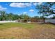 Expansive backyard featuring a well-kept lawn, shade trees, and white fencing at 505 S Larry Cir, Brandon, FL 33511