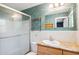 Bathroom features a shower with glass door, updated vanity and granite countertop at 505 S Larry Cir, Brandon, FL 33511