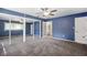 Spacious bedroom featuring a ceiling fan, mirrored closet doors and neutral carpeting at 505 S Larry Cir, Brandon, FL 33511