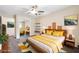 Bright bedroom features a queen bed with a stylish wood frame, colorful rug, and mirrored closet at 505 S Larry Cir, Brandon, FL 33511