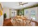 Bright dining room with wood floors, french doors to patio, and serene nature mural at 505 S Larry Cir, Brandon, FL 33511