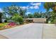 Beautifully landscaped front yard with mature trees and colorful plants enhances the curb appeal of this charming home at 505 S Larry Cir, Brandon, FL 33511