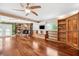 Spacious living room with hardwood floors, a stone fireplace, and built-in bookshelves at 505 S Larry Cir, Brandon, FL 33511