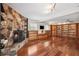 Spacious living room with a stone fireplace, hardwood floors, built-in bookshelves and lots of natural light at 505 S Larry Cir, Brandon, FL 33511