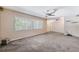 Inviting living room featuring neutral walls, carpet, and a large window for natural light at 505 S Larry Cir, Brandon, FL 33511