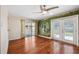 Bright living room featuring hardwood floors, mural, and sliding doors to outdoor patio at 505 S Larry Cir, Brandon, FL 33511