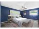 Serene main bedroom with blue walls, two windows, and a ceiling fan to create a calm, relaxing atmosphere at 505 S Larry Cir, Brandon, FL 33511
