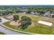 Aerial view showcasing community amenities, including tennis courts and a playground surrounded by lush greenery at 5316 Ladywell Ct, Tampa, FL 33624