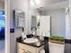 Bathroom features a black granite countertop, neutral paint, and decorative dog statues at 5316 Ladywell Ct, Tampa, FL 33624