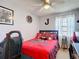 Bedroom with fan, Buccaneers themed bedding and artwork, with lots of natural light at 5316 Ladywell Ct, Tampa, FL 33624