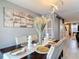 Formal dining room featuring table set for six, modern lighting, and sliding glass doors at 5316 Ladywell Ct, Tampa, FL 33624