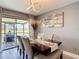 Formal dining room featuring table set for six, modern lighting, and sliding glass doors at 5316 Ladywell Ct, Tampa, FL 33624