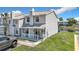 Two-story townhouse with covered porch, neat landscaping, and lakeside view, perfect for relaxed living at 5316 Ladywell Ct, Tampa, FL 33624