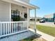 Charming front porch with white railing, decorative plants, and a welcoming entrance at 5316 Ladywell Ct, Tampa, FL 33624