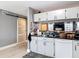 Bright kitchen featuring white cabinets, black countertops, and stainless steel sink at 5316 Ladywell Ct, Tampa, FL 33624