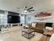 Cozy living room featuring a plush sectional sofa, stylish decor, and entertainment center with a large TV at 5316 Ladywell Ct, Tampa, FL 33624