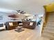 Spacious living room with comfortable sectional sofa, modern decor, and staircase leading to the upper level at 5316 Ladywell Ct, Tampa, FL 33624