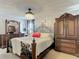 Comfortable main bedroom featuring a decorative bed frame, and antique wood furniture at 5316 Ladywell Ct, Tampa, FL 33624