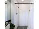Modern shower features subway tile, matte black hardware, and a black-and-white mosaic tile floor at 5316 Ladywell Ct, Tampa, FL 33624