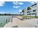 Dock view of water with a building in the background and blue skies at 5555 Gulf Blvd # 204, St Pete Beach, FL 33706