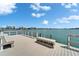 Dock featuring view of water, distant buildings, and clear blue skies at 5555 Gulf Blvd # 204, St Pete Beach, FL 33706