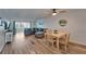 Spacious living room boasts hardwood floors, a comfortable gray sectional, and a dining area at 5555 Gulf Blvd # 204, St Pete Beach, FL 33706