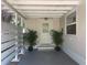 Covered patio featuring a white door and potted plants, offering a cozy and inviting outdoor space at 5725 2Nd N Ave, St Petersburg, FL 33710