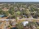 Wide aerial view of a mature neighborhood with sidewalks, and mature trees, and proximity to a tennis court at 614 Sandalwood Dr, Plant City, FL 33563