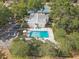Aerial view of the community pool, clubhouse, tennis courts, and parking at 614 Sandalwood Dr, Plant City, FL 33563
