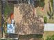 Aerial view of the house showing the roof, back patio, and colorful landscaping at 614 Sandalwood Dr, Plant City, FL 33563