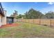 Spacious backyard featuring a well-maintained lawn and a cozy seating area adjacent to the house at 614 Sandalwood Dr, Plant City, FL 33563