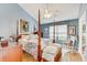 Spacious bedroom with vaulted ceiling, ceiling fan, and a four-poster bed at 614 Sandalwood Dr, Plant City, FL 33563