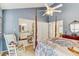 Cozy bedroom with a four-poster bed, view to the bathroom, rocking chair and bright walls at 614 Sandalwood Dr, Plant City, FL 33563