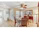 Cozy dining area with a ceiling fan, natural light, and wood-look flooring at 614 Sandalwood Dr, Plant City, FL 33563