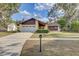 Charming single-Gathering home featuring a well-maintained front yard and a two-car garage at 614 Sandalwood Dr, Plant City, FL 33563