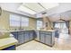 Bright kitchen featuring tile floors, stainless appliances, and view into the living area at 614 Sandalwood Dr, Plant City, FL 33563