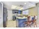 Charming kitchen with blue cabinets, stainless appliances, and breakfast bar with bar stools at 614 Sandalwood Dr, Plant City, FL 33563