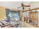 Cozy living room with vaulted ceilings, ceiling fan and sliding glass doors to the patio at 614 Sandalwood Dr, Plant City, FL 33563