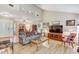 Open-concept living space with wood-look floors, a fireplace, and plenty of room for entertaining at 614 Sandalwood Dr, Plant City, FL 33563