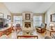 Comfortable living room with a fireplace and large windows providing lots of natural light at 614 Sandalwood Dr, Plant City, FL 33563