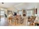 Inviting living room featuring a vaulted ceiling, a cozy fireplace, and wood-look flooring at 614 Sandalwood Dr, Plant City, FL 33563