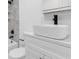 Modern bathroom featuring white vanity with rectangular sink, dark faucet and white tiled wall at 621 85Th N Ave, St Petersburg, FL 33702