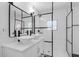 Modern bathroom featuring dual vessel sinks, black framed mirror and a glass-enclosed shower at 621 85Th N Ave, St Petersburg, FL 33702