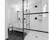 Modern bathroom with marble floors, vanity with framed mirror and a glass-enclosed shower at 621 85Th N Ave, St Petersburg, FL 33702