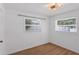 Bright bedroom with stylish ceiling light, neutral walls, wood-look floors and windows at 621 85Th N Ave, St Petersburg, FL 33702