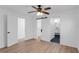 Bright bedroom with ceiling fan, wood-look floors, and doorways to bathroom and other rooms at 621 85Th N Ave, St Petersburg, FL 33702