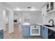 Updated kitchen featuring stainless steel appliances and an island with blue cabinets at 621 85Th N Ave, St Petersburg, FL 33702