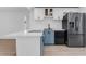 Kitchen featuring stainless steel appliances and white cabinetry with blue island at 621 85Th N Ave, St Petersburg, FL 33702
